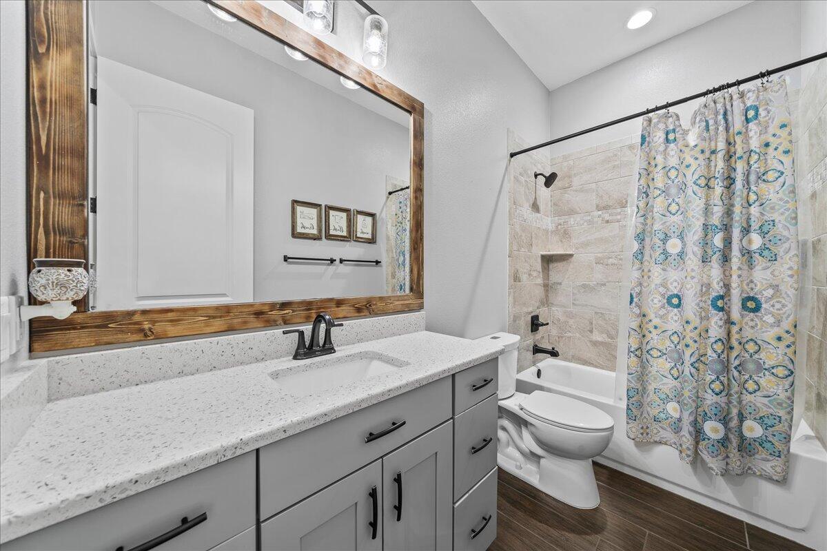 3490 Grant Line Road Mims, FL 32754 - Photo 18 of 43 a bathroom with a granite countertop sink a toilet and a mirror