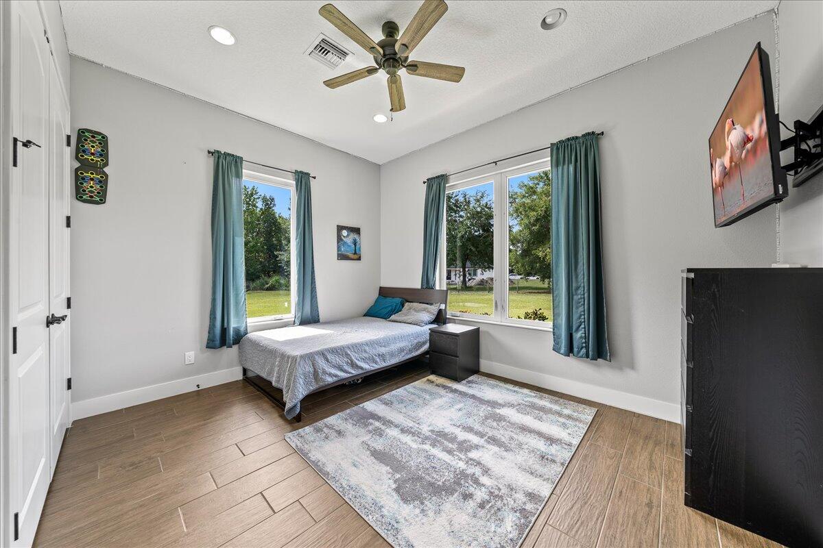 3490 Grant Line Road Mims, FL 32754 - Photo 19 of 43 a living room with a bed furniture and a large window