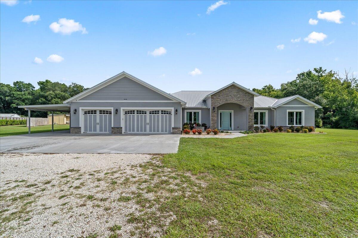 3490 Grant Line Road Mims, FL 32754 - Photo 2 of 43 a front view of a house with garden