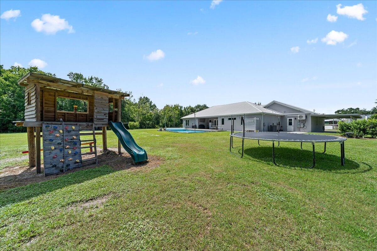 3490 Grant Line Road Mims, FL 32754 - Photo 30 of 43 a view of a house with backyard and a slide
