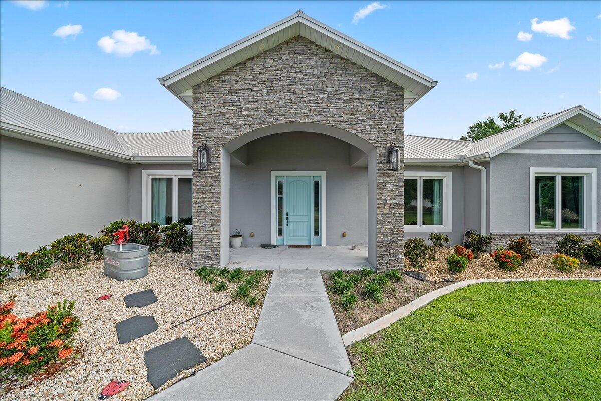 3490 Grant Line Road Mims, FL 32754 - Photo 3 of 43 a front view of a house with patio