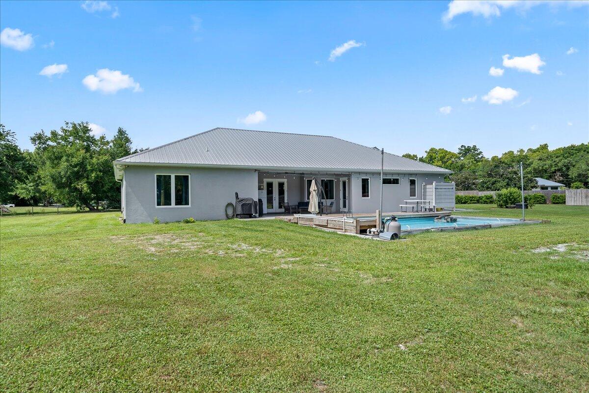 3490 Grant Line Road Mims, FL 32754 - Photo 31 of 43 a front view of a house with a garden