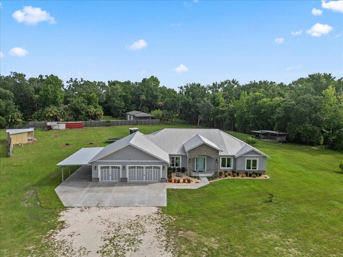 3490 Grant Line Road Mims, FL 32754 - Photo 34 of 43 a front view of a house with garden