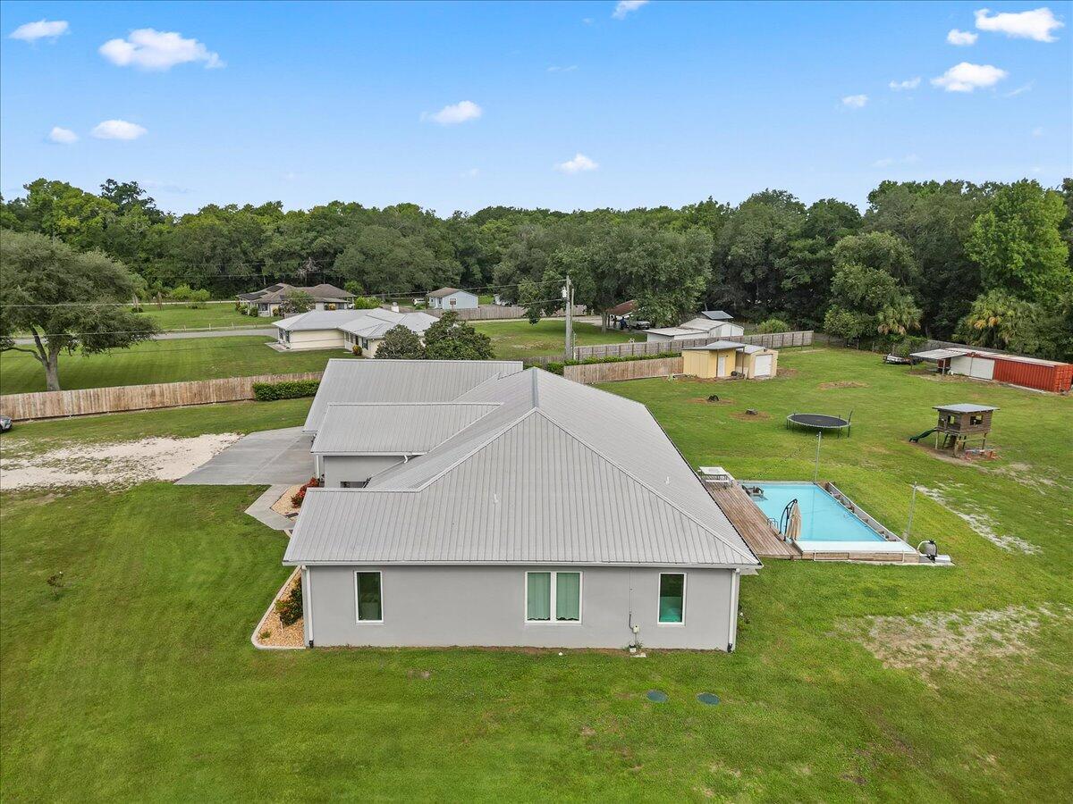 3490 Grant Line Road Mims, FL 32754 - Photo 37 of 43 a aerial view of a house next to a lake with a big yard