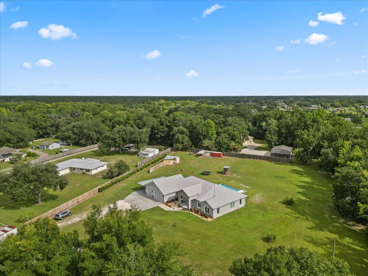 3490 Grant Line Road Mims, FL 32754 - Photo 39 of 43 a view of a swimming pool with an outdoor seating and yard
