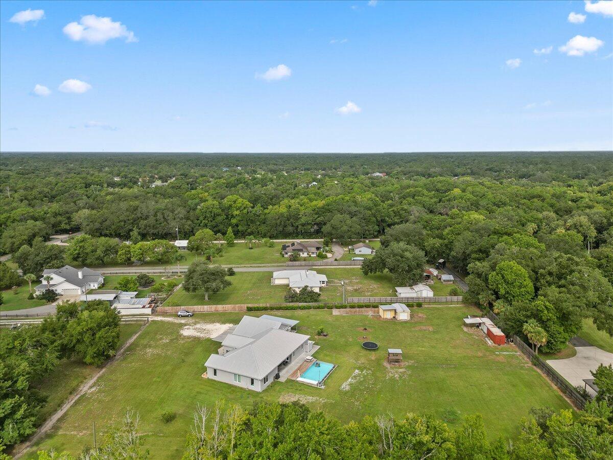 3490 Grant Line Road Mims, FL 32754 - Photo 40 of 43 a view of a lake with lawn chairs and large trees