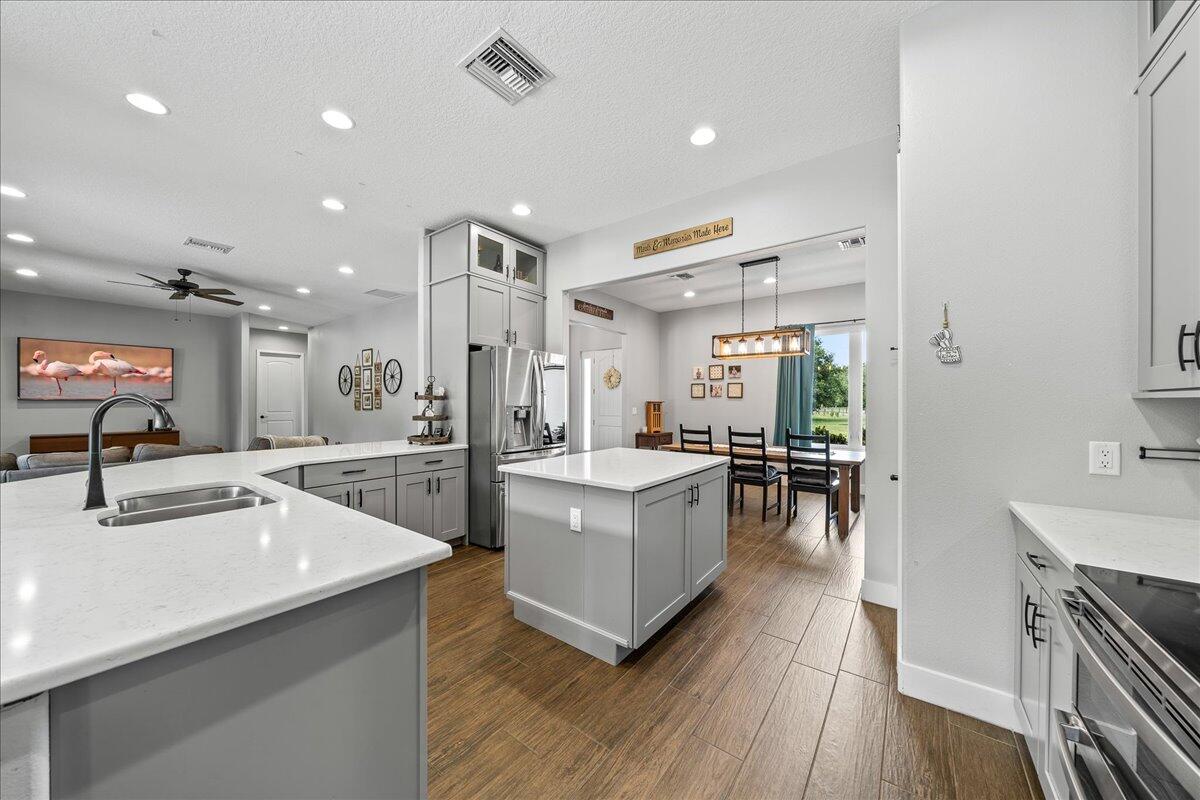 3490 Grant Line Road Mims, FL 32754 - Photo 9 of 43 a kitchen with counter top space a sink appliances and cabinets