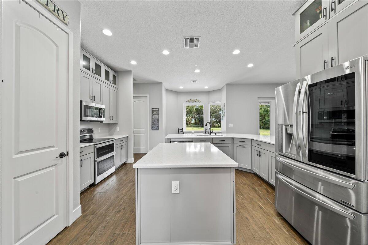 3490 Grant Line Road Mims, FL 32754 - Photo 10 of 43 a kitchen with counter top space stainless steel appliances and cabinets