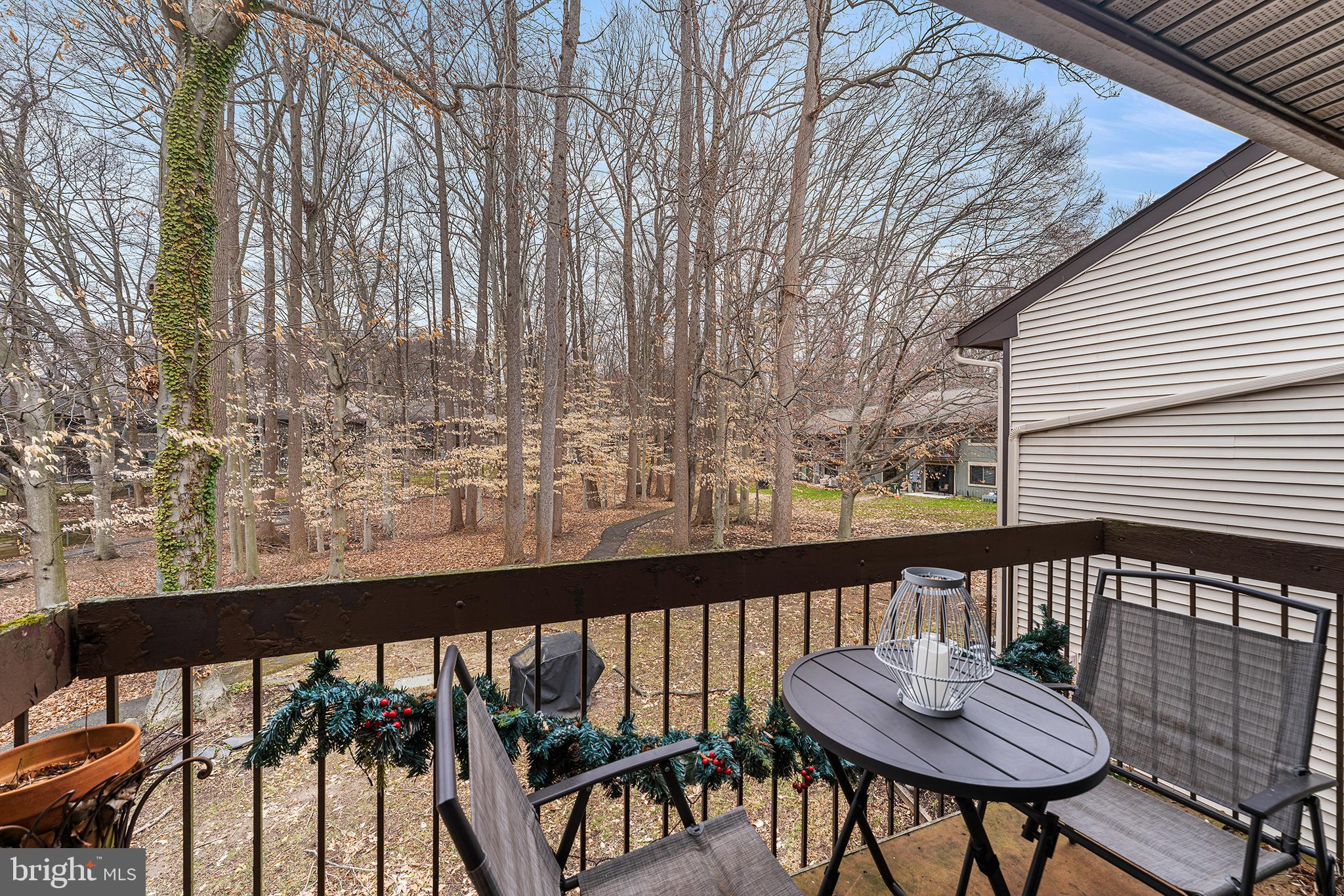 115 East Kings Highway, Unit 186 Maple Shade, NJ 08052 - Photo 21 of 25 a view of a balcony with chairs and wooden fence