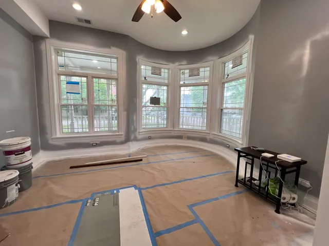 a spacious bathroom with a tub and a large window