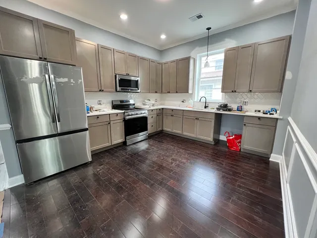 a kitchen with stainless steel appliances a refrigerator sink microwave and cabinets