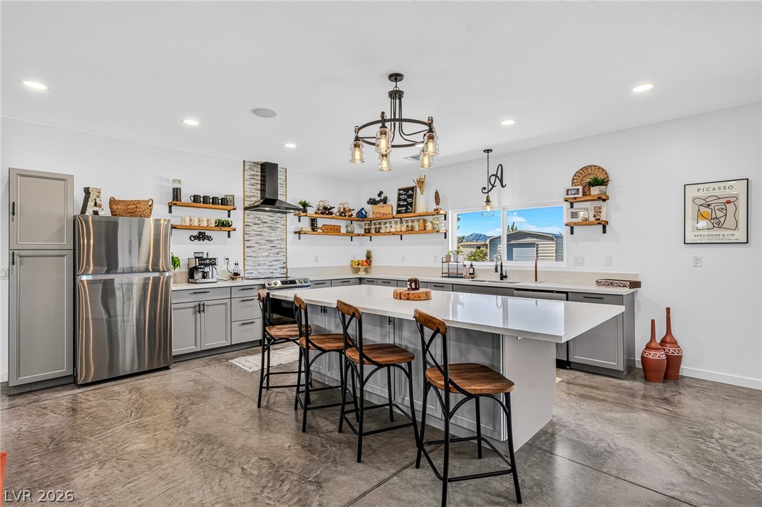 4080 Magnet Road Pahrump, NV 89048 - Photo 2 of 28 Polished concrete floors and a massive center island ground this modern culinary workspace.