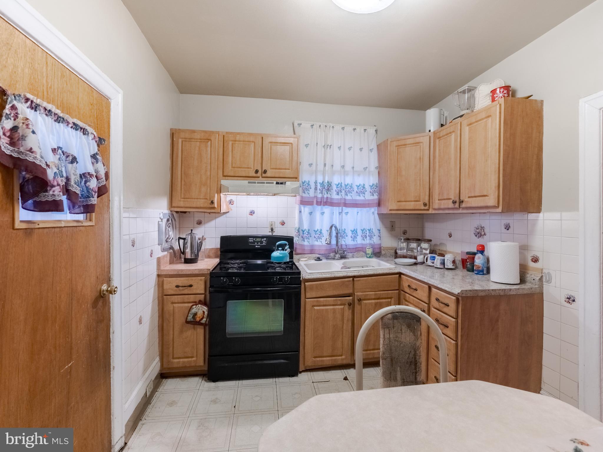 5329 Willows Avenue Philadelphia, PA 19143 - Photo 15 of 32 Cozy kitchen with warm wooden cabinetry.