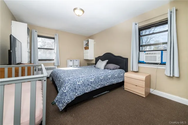 a bedroom with a bed and a window with outer view