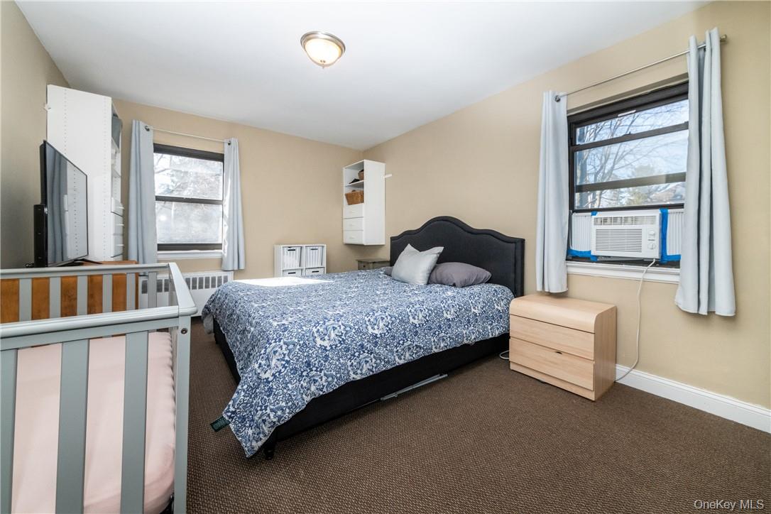 50 White Oak Street, Unit 3G New Rochelle, NY 10801 - Photo 13 of 16 a bedroom with a bed and a window with outer view