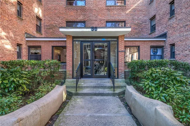 a view of a building with potted plants