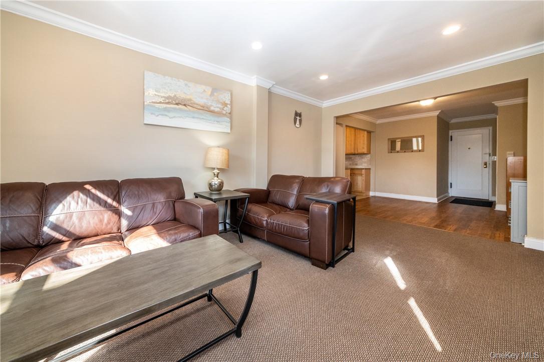 50 White Oak Street, Unit 3G New Rochelle, NY 10801 - Photo 5 of 16 a living room with furniture and a chandelier