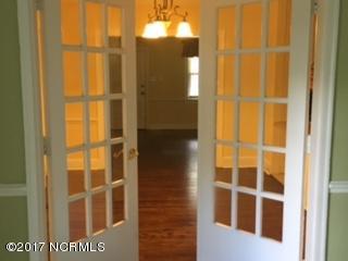 1217 Stockton Road Kinston, NC 28504 - Photo 7 of 20 French doors into formal dining room with view of living room