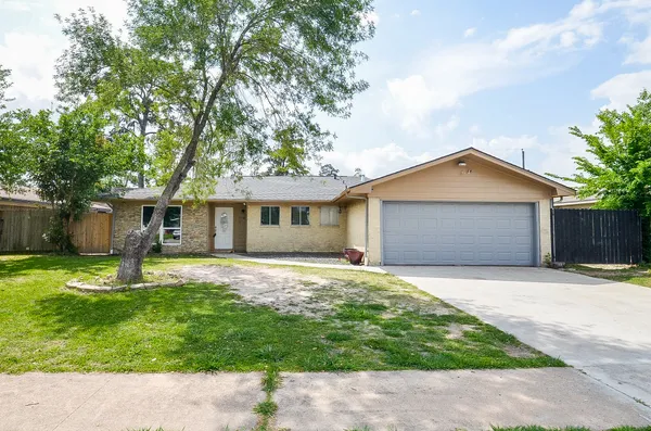 a house with a yard and a large tree