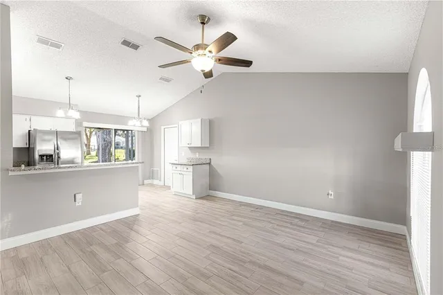 a view of kitchen with window and wooden floor