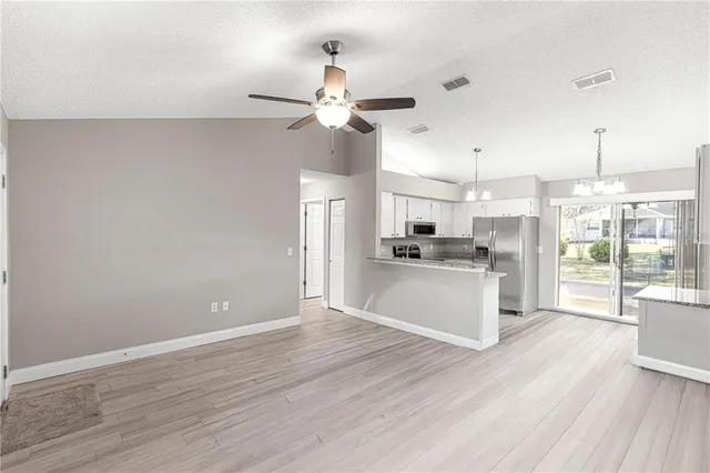 a view of a kitchen with wooden floor and a kitchen island