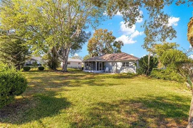 a front view of house with yard and trees