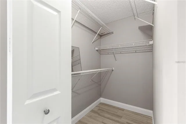 a view of walk in closet with empty racks