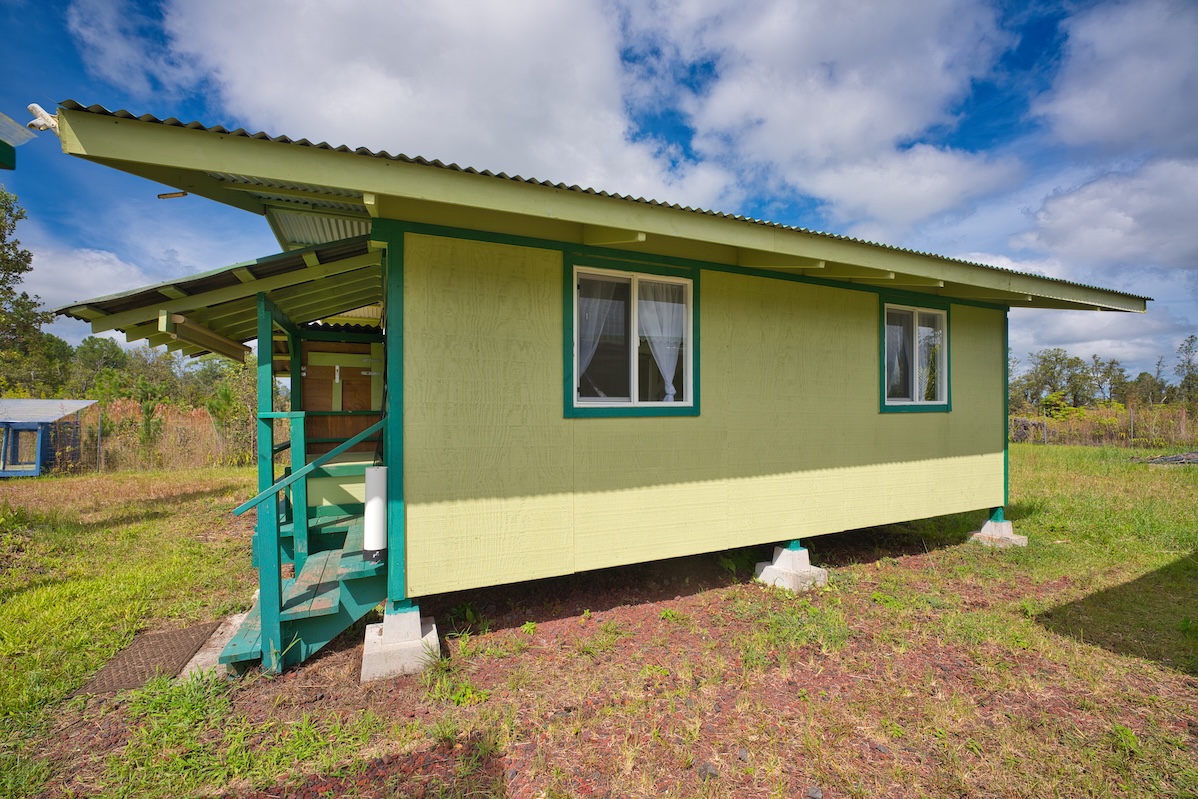11-1984 Ohialani Road Mountain View, HI 96771 - Photo 4 of 19 a yellow house with a large pool in front of it
