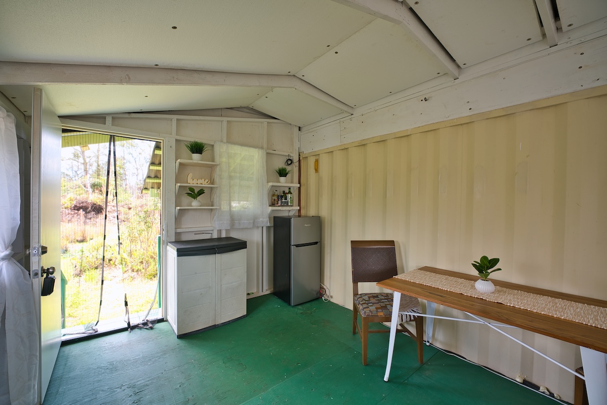 11-1984 Ohialani Road Mountain View, HI 96771 - Photo 6 of 19 a room with a bed and a table chair