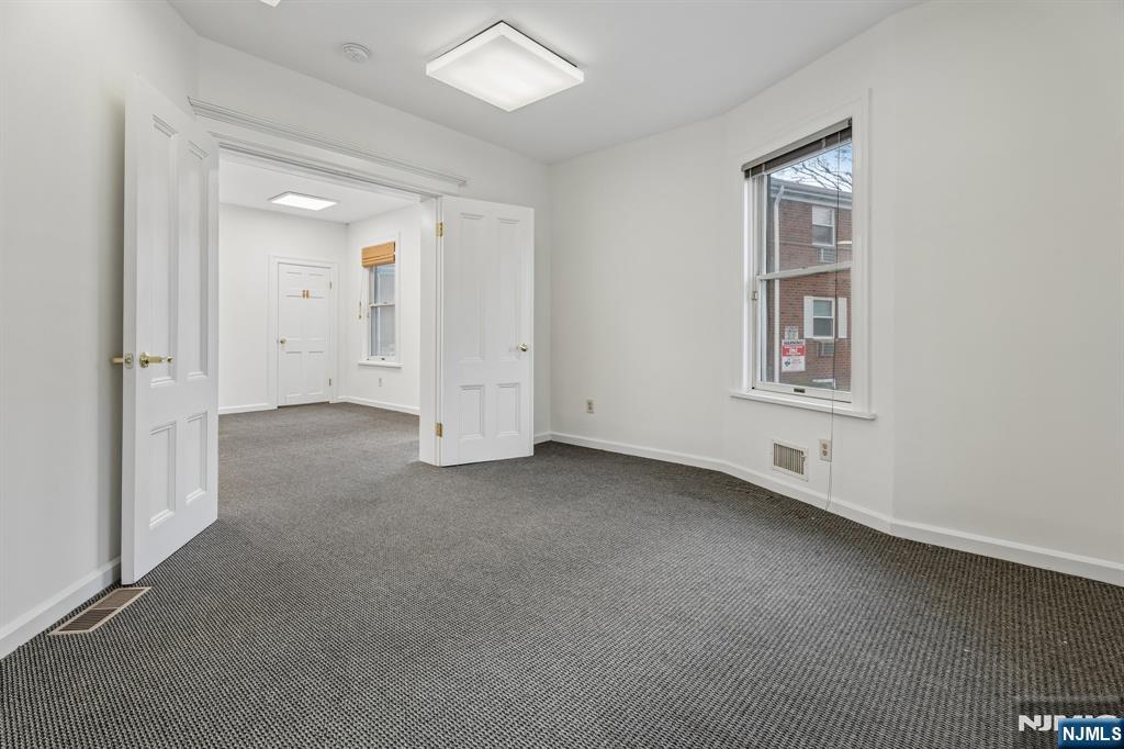 94 Church Street Montclair, NJ 07042 - Photo 14 of 49 an empty room with windows and closet