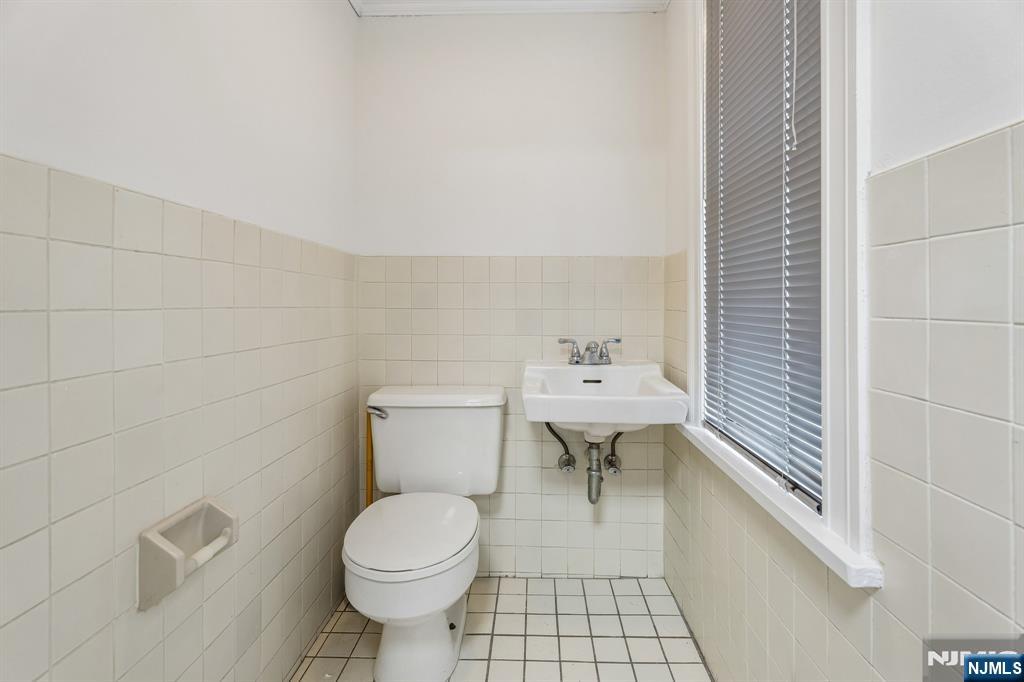 94 Church Street Montclair, NJ 07042 - Photo 15 of 49 a bathroom with a toilet a sink and mirror
