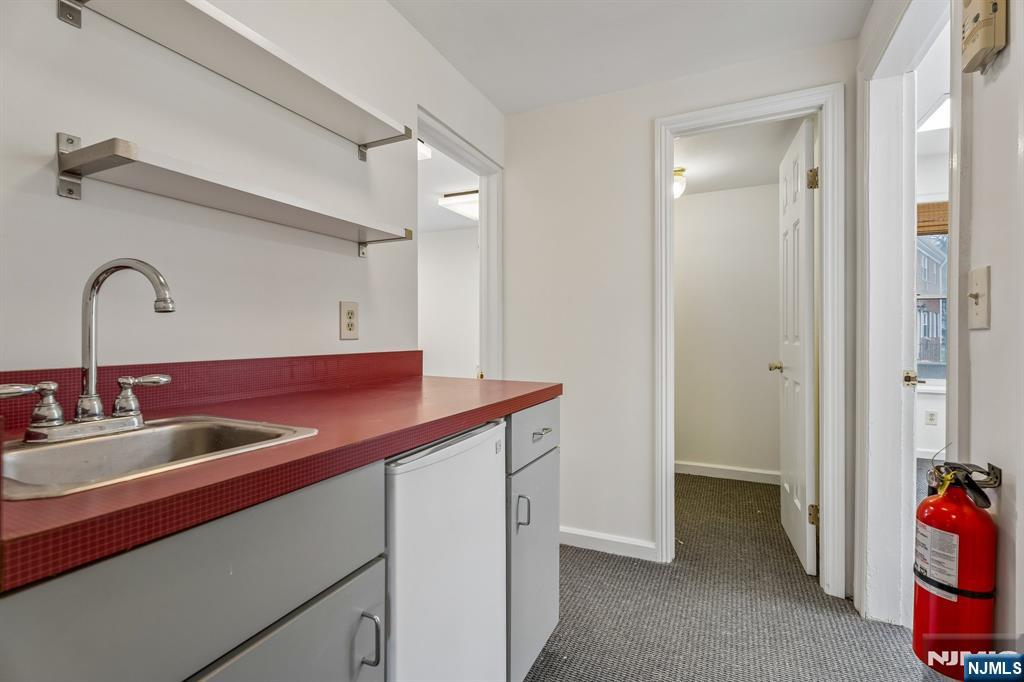 94 Church Street Montclair, NJ 07042 - Photo 19 of 49 a kitchen with a sink and a refrigerator
