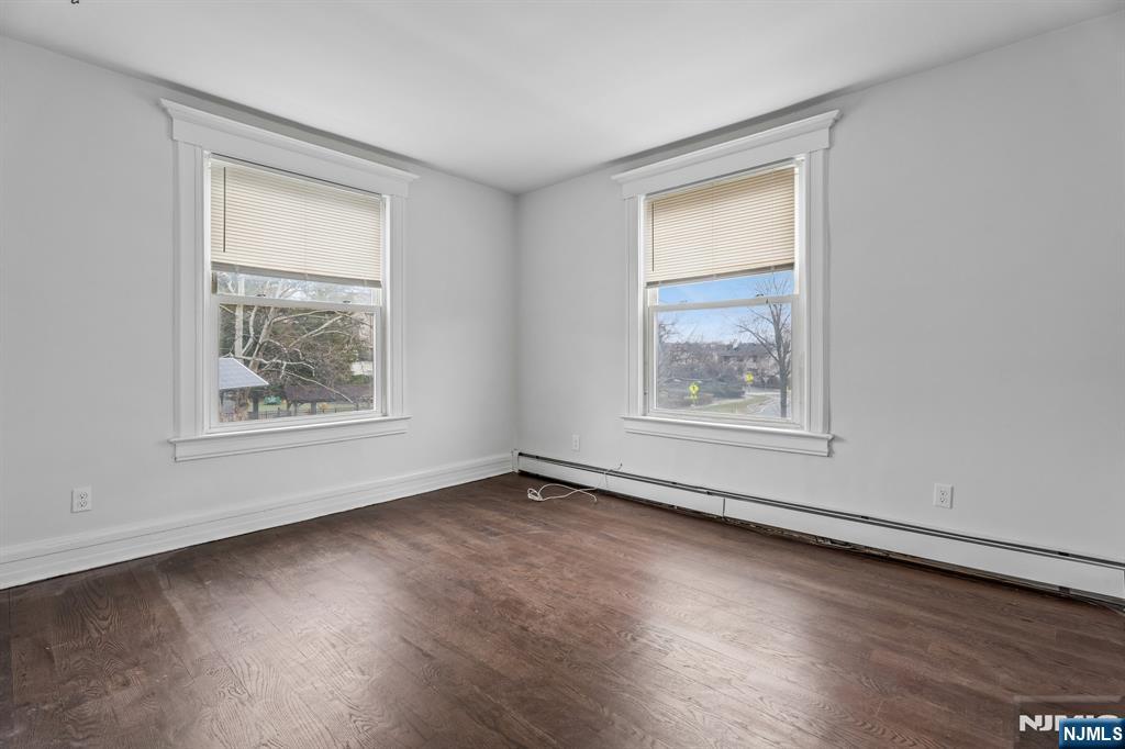 94 Church Street Montclair, NJ 07042 - Photo 24 of 49 a view of an empty room with wooden floor and a window