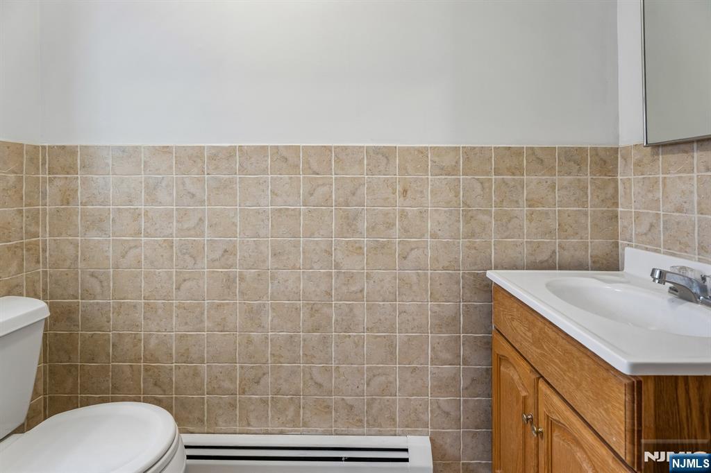 94 Church Street Montclair, NJ 07042 - Photo 27 of 49 a bathroom with a sink a toilet and a mirror