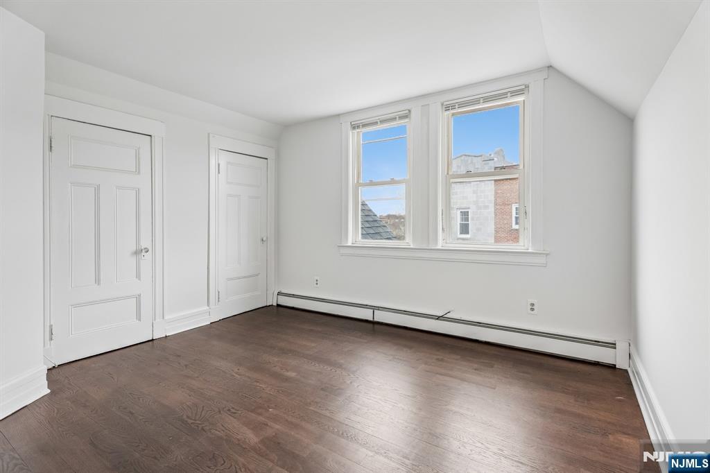 94 Church Street Montclair, NJ 07042 - Photo 29 of 49 an empty room with wooden floor and windows