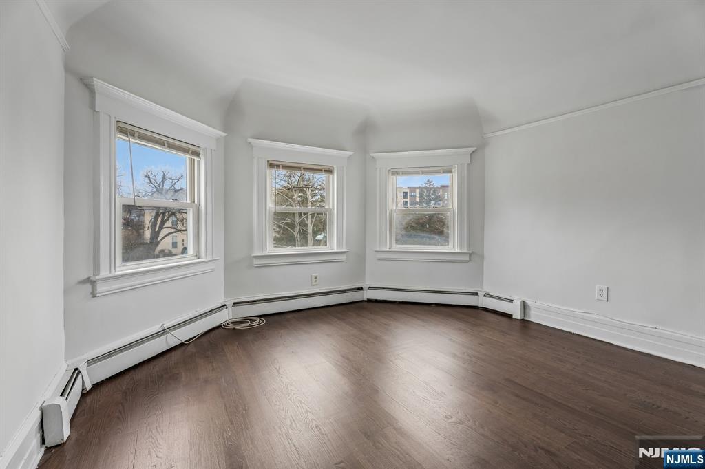 94 Church Street Montclair, NJ 07042 - Photo 31 of 49 a view of an empty room with a window and wooden floor