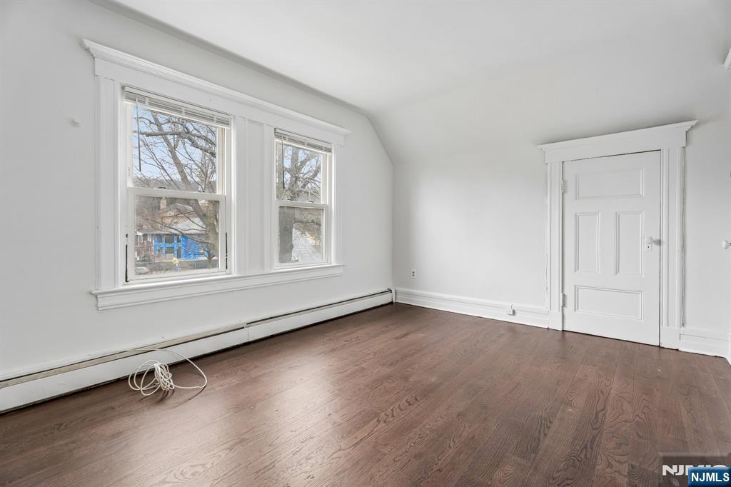 94 Church Street Montclair, NJ 07042 - Photo 33 of 49 an empty room with wooden floor and windows