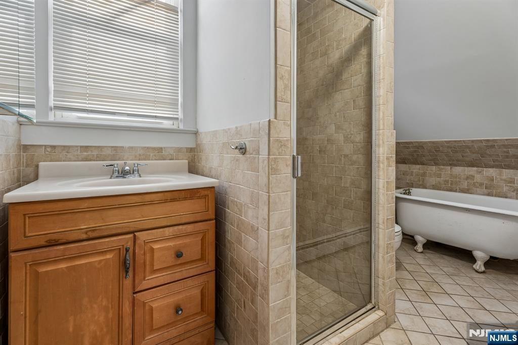 94 Church Street Montclair, NJ 07042 - Photo 35 of 49 a bathroom with a bathtub and a sink