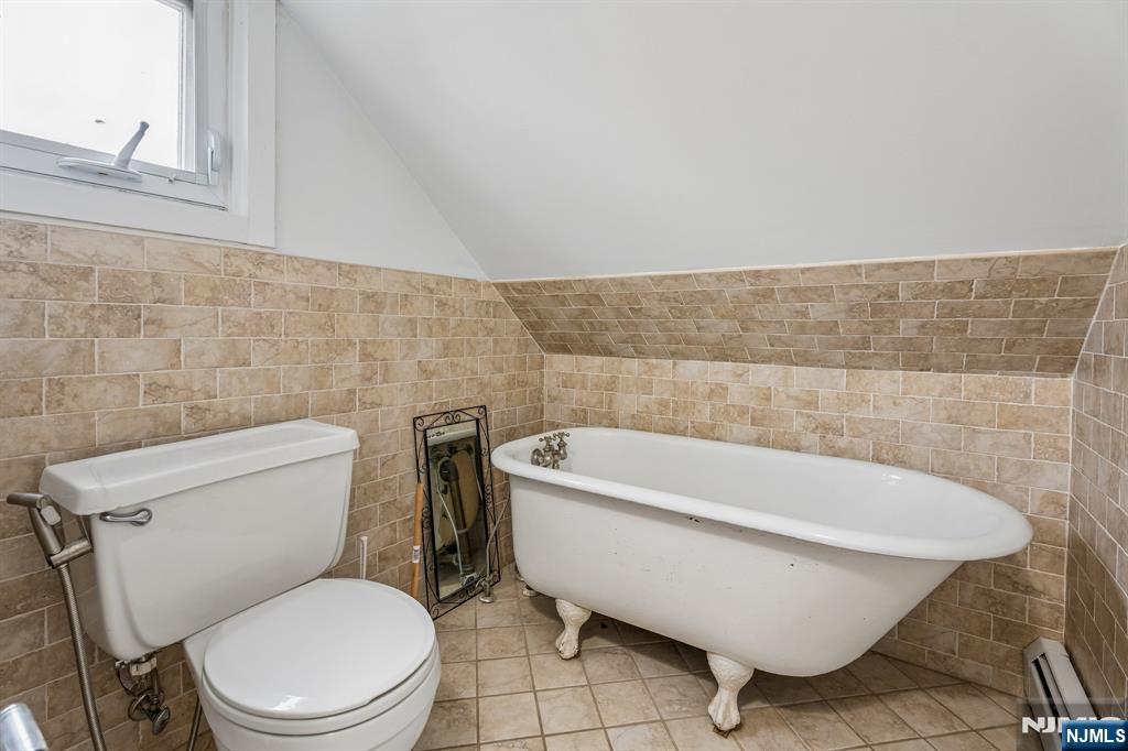 94 Church Street Montclair, NJ 07042 - Photo 36 of 49 a bathroom with a toilet and bathtub