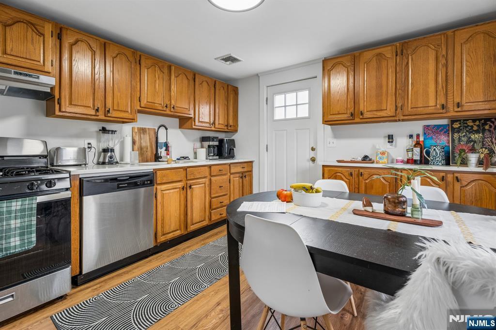 94 Church Street Montclair, NJ 07042 - Photo 42 of 49 a kitchen with stainless steel appliances granite countertop a stove a sink dishwasher and cabinets with wooden floor