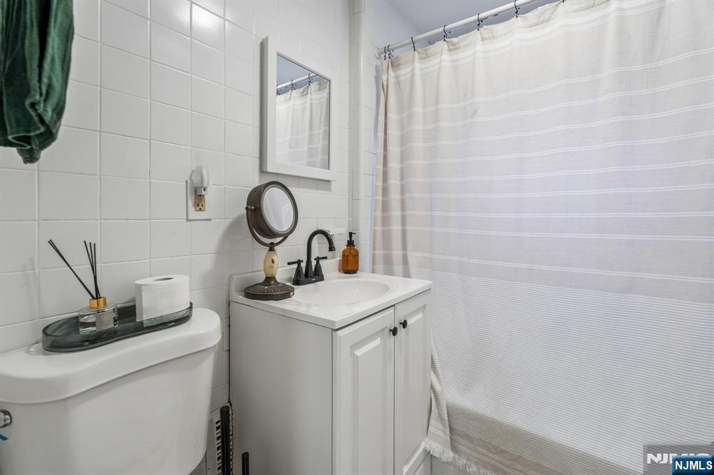 94 Church Street Montclair, NJ 07042 - Photo 45 of 49 a bathroom with a sink a toilet and a mirror