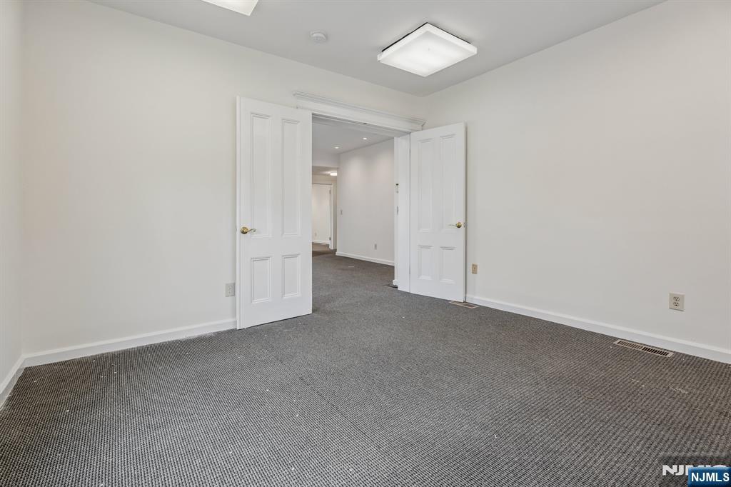 94 Church Street Montclair, NJ 07042 - Photo 5 of 49 an empty room with a empty space and a ceiling fan