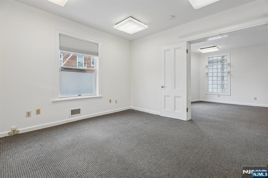 94 Church Street Montclair, NJ 07042 - Photo 6 of 49 an empty room with windows and closet