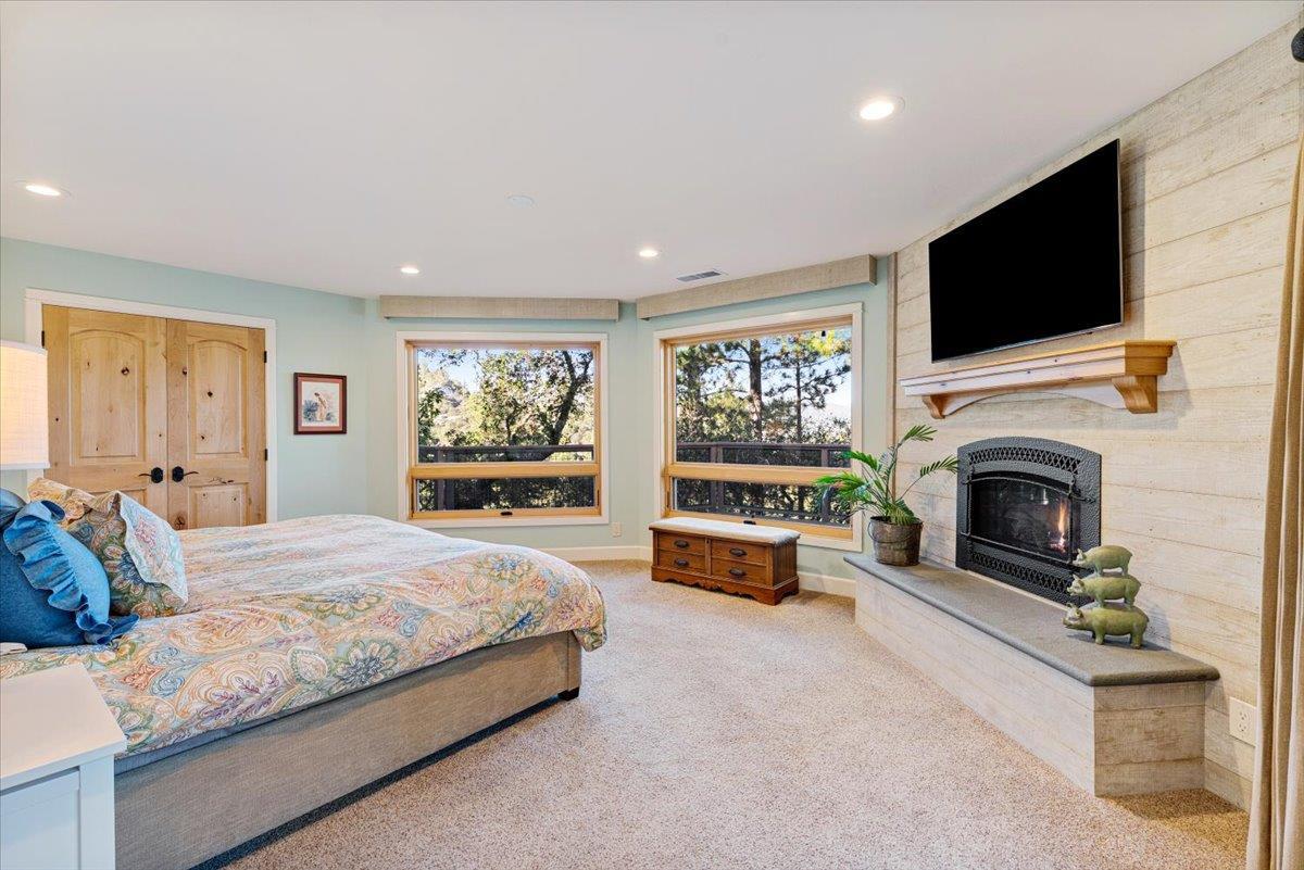 7409 Hihn Road Ben Lomond, CA 95005 - Photo 37 of 101 a spacious bedroom with a bed and a flat screen tv