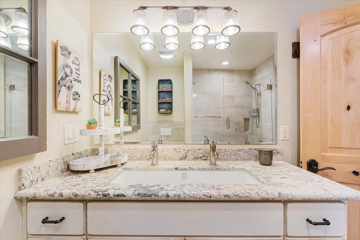 7409 Hihn Road Ben Lomond, CA 95005 - Photo 58 of 101 a bathroom with a granite countertop sink a mirror and shower