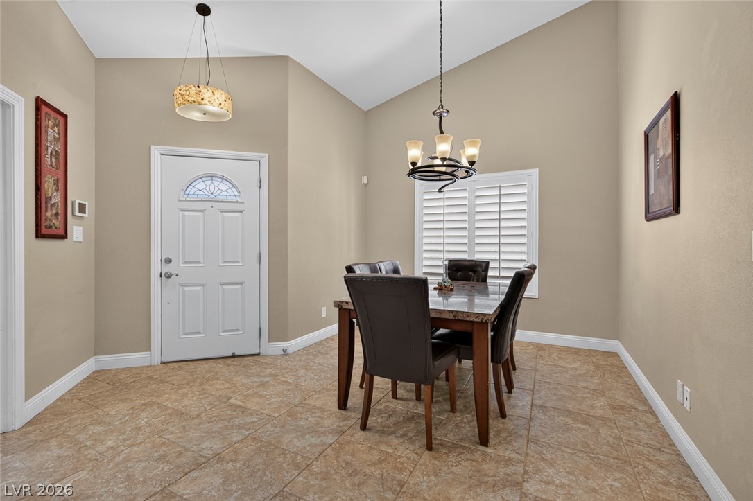 818 Manor Shores Road Henderson, NV 89002 - Photo 7 of 35 Enter into an inviting dining area, boasting vaulted ceilings and durable tile flooring perfect for entertaining.