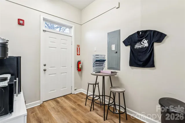 a view of a hallway with wooden floor and closet