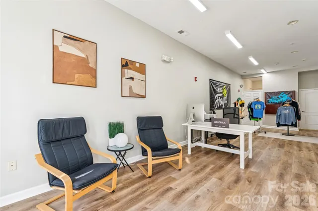 a living room with furniture a rug and a table