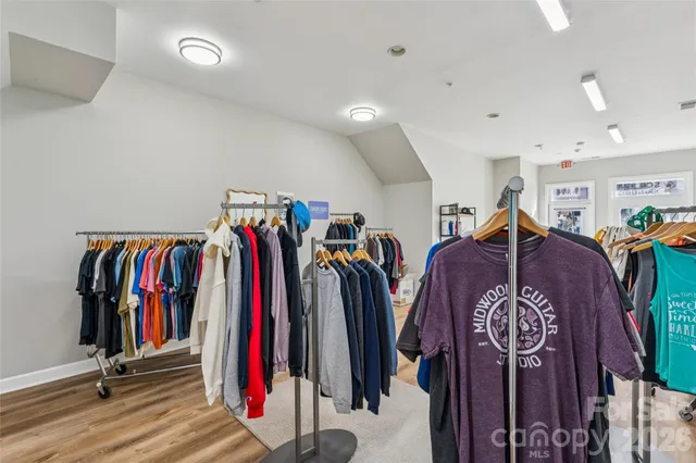 a view of walk in closet with clothes
