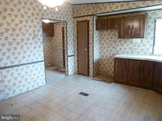 a kitchen with a sink and wooden cabinets